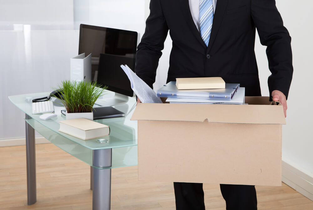 Businessman-carrying-a-box-with-office-items