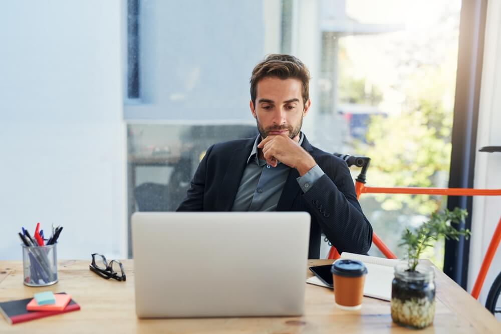 Business man thinking with laptop
