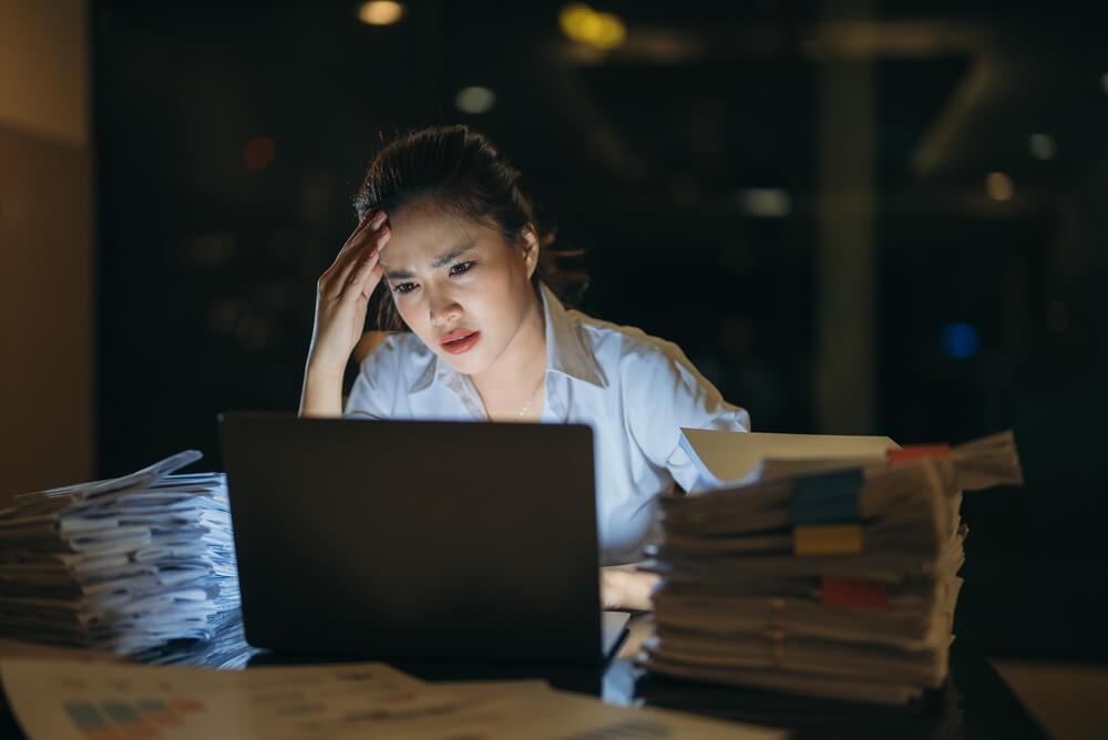 Stressed woman looking at her laptop
